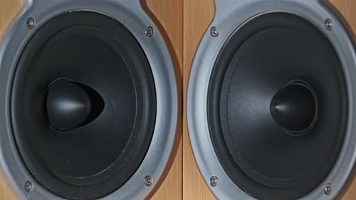 Two Audio Speakers Vibrate From Sound Bass in Slow Motion Stereo Closeup