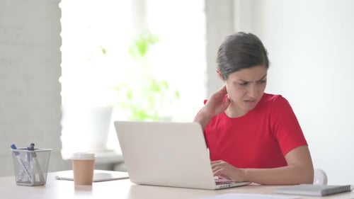 Indian Woman Having Neck Pain While Using Laptop in Office