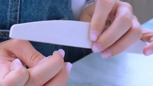 Woman Files Nails in a Home Setting