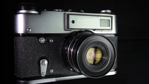 Vintage Film Camera Rotating on Dark Background