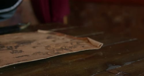 Hand Opens Antique Wooden Music Box Next to Map