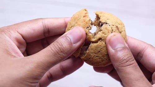 Close Up of Man Hand Breaking Cookies