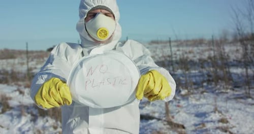 Virologist Constricts Plastic Plate with Inscription "Stop Plastic"