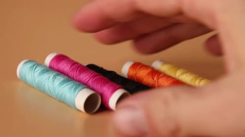 Spools of Colorful Sewing Thread Arranged on Table