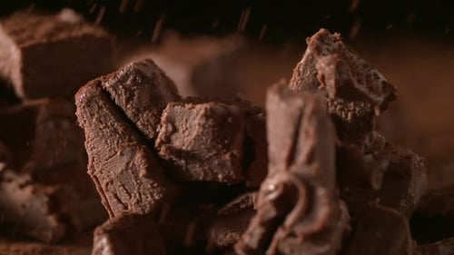 Rich Dark Chocolate Chunks With Fine Powder Falling