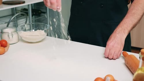 Close Up of Man Hand Sieving Flour