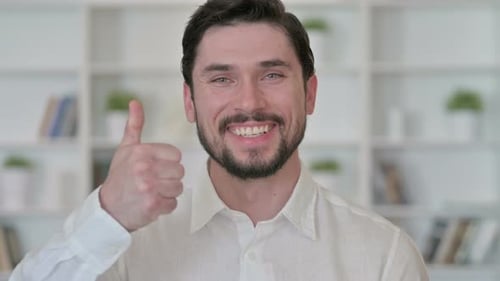 Man Smiling and Giving Thumbs Up Gesture