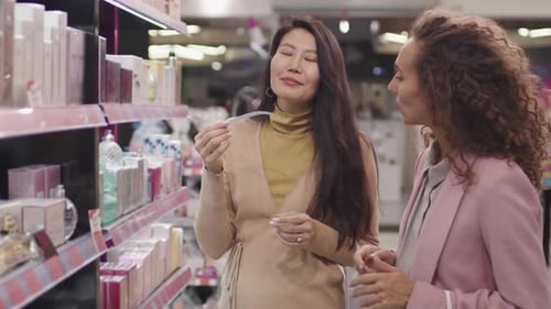 Women Discussing Fragrance Notes In Beauty Shop