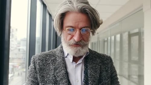 Senior Stylish Man in Glasses Put on Face Mask in the Airport
