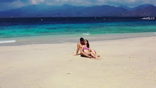 Teenage lovers happy together on perfect coastline beach wildlife by aqua blue sea with white sandy