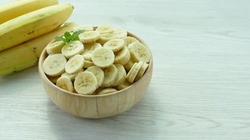 Sliced Banana Fruit in Wooden Bowl Close Up