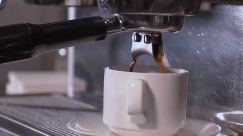 Espresso Machine Brewing Fresh Coffee into a Cup