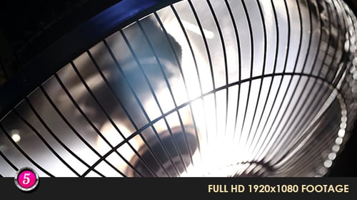 Close Up of a Rotating Metal Fan at Night