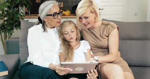 Three Generations of Women Looking at Tablet