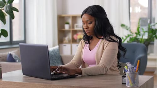 Stressed Woman with Laptop Working at Home Office