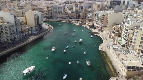 Beautiful aerial view of the Spinola Bay, St. Julians and Sliema town on Malta. Many white boats are