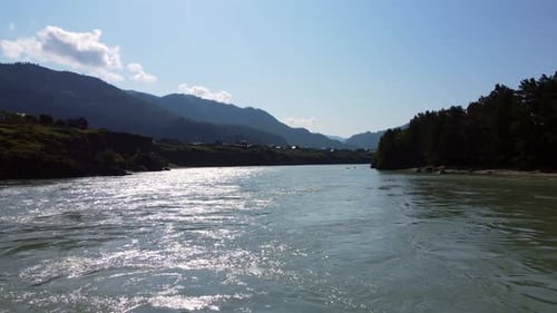 Summer Landscape with a River and High Mountains