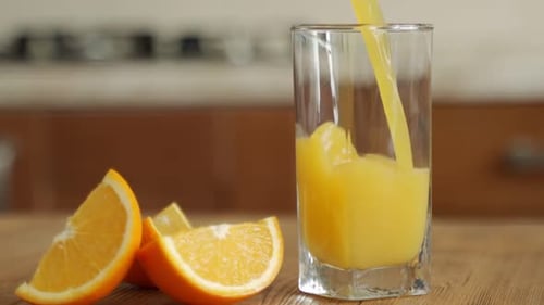 Pouring Fresh Orange Juice into a Glass