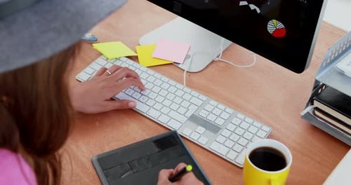 Graphic Designer Working at Desk With Technology
