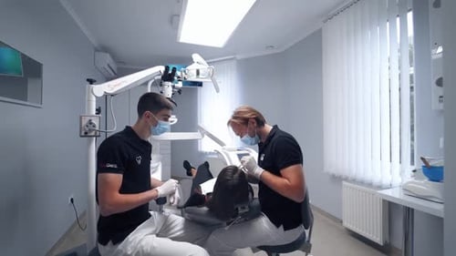 Woman in dental clinic. Dentist working with female teeth in dental clinic