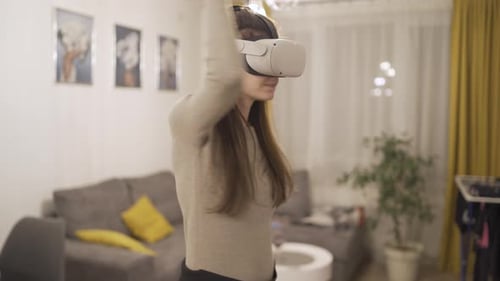 Woman Immersed in VR Gaming Experience at Home