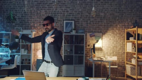 Slow Motion of Happy Young Man Dancing in Office Wearing Funny Glasses