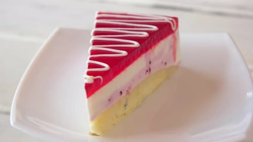 Rotating slice of delicious layer cake with frosting
