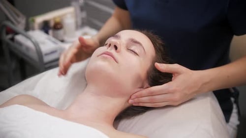 Young Woman Receives a Relaxing Facial Massage