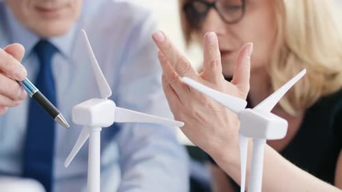 Executives Discuss Wind Turbine Technology in Office