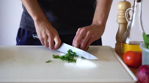 Fresh Spring Onion Sliced In White Chopping Board By Sharp Knife. - High Angle Shot