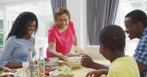 Smiling Family Enjoying Meal Together at Home