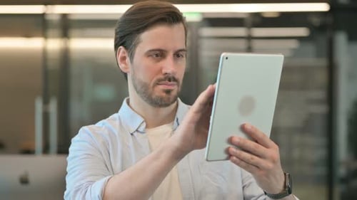 Man Using Tablet in Modern Office Setting