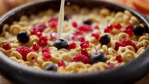 Milk Being Poured Into Cereal and Fruit