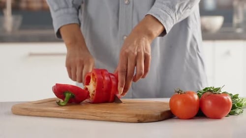 Close Up Footage of Female's Hands Slicing Red Pepper to Make Salad with Tomatoes in Slowmotion