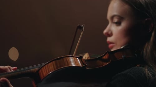Classic Music Concert in Opera House Female Violinist is Playing Violin in Dark Philharmonic Hall