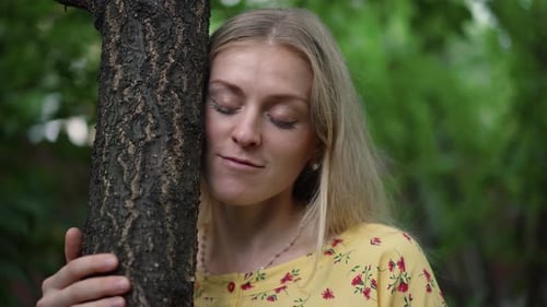 Woman Embraces Tree in the Park