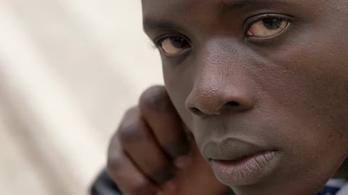 Pensive, serious young black man staring at camera - close up
