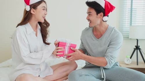 Loving Couple Exchanging Gifts for Christmas Holiday