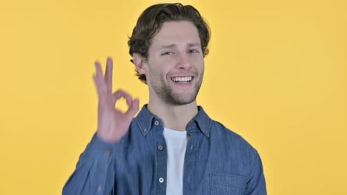 Man Smiles and Forms OK Sign