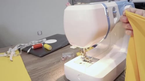 Sewing Machine Stitching Bright Yellow Fabric