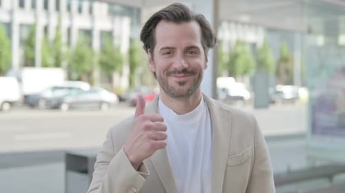 Man Giving Thumbs Up in Urban Setting