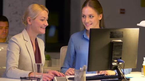 Businesswomen with Computer Working Late at Office