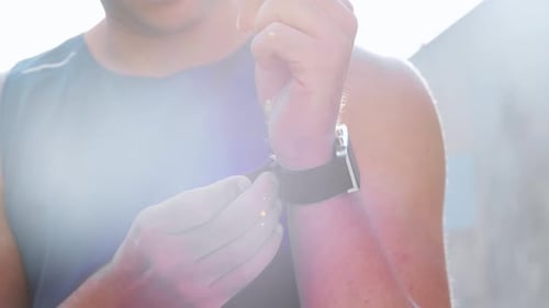 Young Man Uses Smartwatch Technology Outside