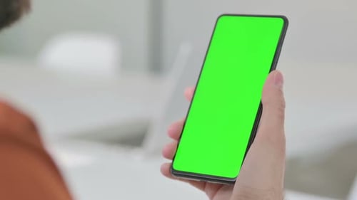Close Up of Young Man Using Smartphone with Green Chroma Key Screen