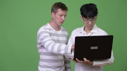 Two Young Adults Reviewing Laptop Together