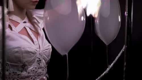 Woman Manipulates Iridescent Soap Bubbles in Costume