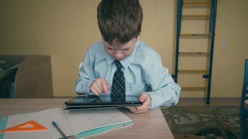 Boys Studying with Tablet and Writing in Class