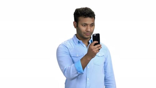 Young Adult Man Uses Smartphone on White Background