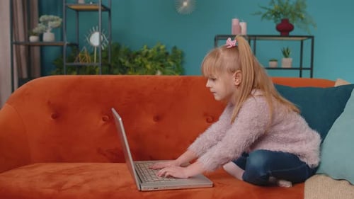 Joyful School Kid Girl Use Laptop Computer Learning Reading Online Education Lessons Alone at Home