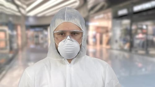 Man in Protective Suit and Mask Indoors